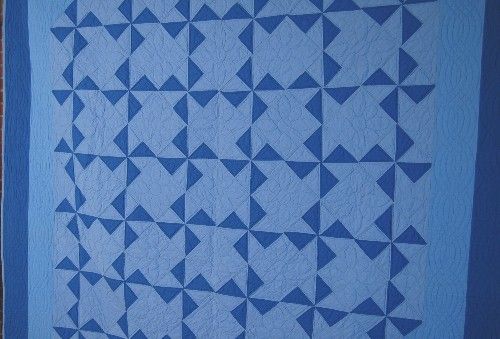 This BEAUTIFUL cotton 20s/30s Amish pinwheels quilt is hand pieced 