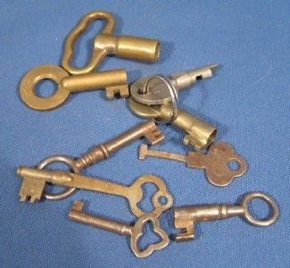  antique grouping of brass and cast iron keys. One of the brass keys 